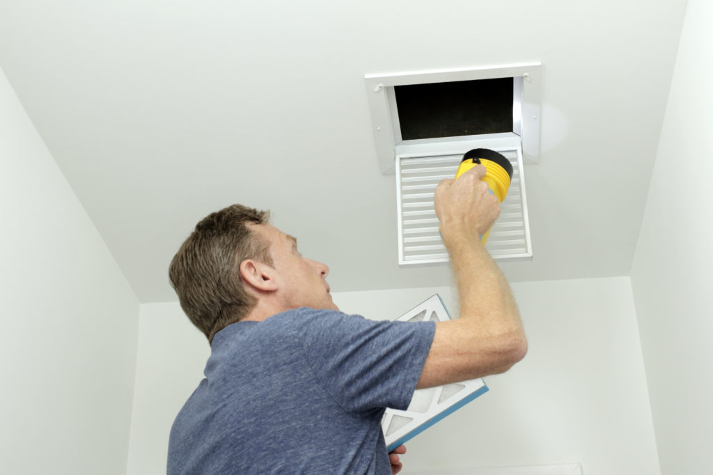Man fixing air ducts